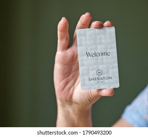 BEMIDJI, MN - 20 JUL 2020: Womans Hand Holding Room Security Keycard For Sheraton Hotels In Close-up View.