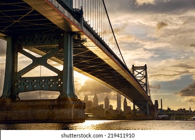 Ben Franklin Bridge above Philadelphia skyline at sunset, US