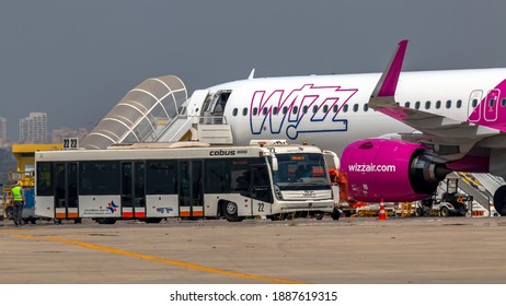 Ben Gurion Airport, Israel - September 19, 2019: A shuttle bus to transport passengers to a plane is parked next to Wizz Air Airbus A321Neo at Ben Gurion Airport