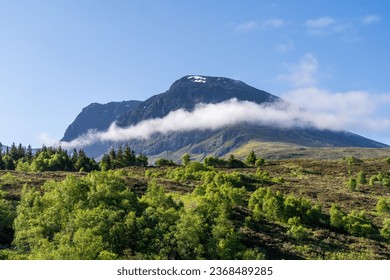 Ben Nevis With a Cloud Below the Summit and a Forest in the Foreground in Scotland United Kingdom - Powered by Shutterstock