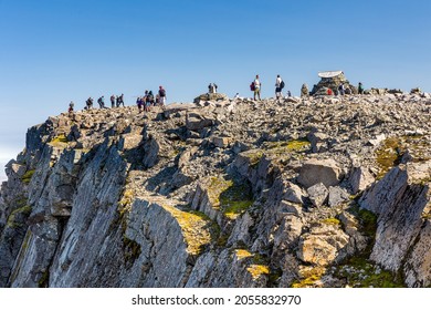 BEN NEVIS, SCOTLAND - SEPTEMBER 01 2021: Hikers On The Summer Of Ben Nevis On A Hot, Clear Day. Ben Nevis Is The Tallest Peak In The United Kingdom