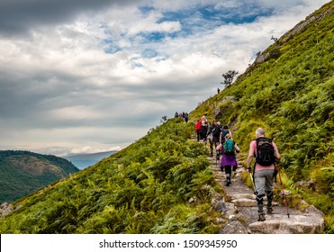 Ben Nevis / UK - August 24 2019: People Hike On 'Mountain Path', The Most Popular Route Up Ben Nevis, In The Scottish Highlands.