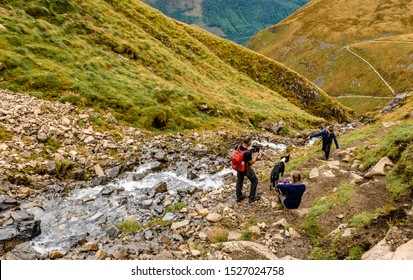 Ben Nevis / UK - August 24 2019: A Family With Their Dog Hike On 'Mountain Path', The Most Popular Route Up Ben Nevis, In The Scottish Highlands.