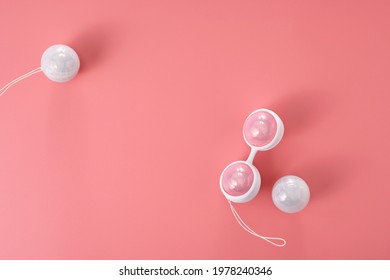 Ben Wa vaginal pleasure balls, Kegel balls on pink background, top view, soft light, empty space for text