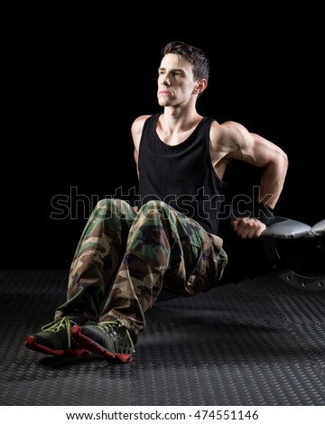 Bench dip exercise. Studio shot over black.