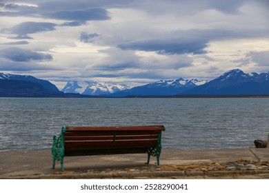 Bench facing the Admiral Montt Gulf on the waterfront of Puerto Natales, Patagonia, Chile, Magallanes and Antartica Chilena Region - Powered by Shutterstock