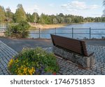 Bench and flowerbed on embankment of lake in summer in  Keuruu, town and municipality of Finland