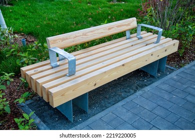 A Bench Made Of Wooden Bars On Yellow Metal Supports In The Courtyard Of The House Outdoors. Sports Healthy Lifestyle Hobby.