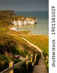 A bench offering a view over Selwicks Bay, near Flamborough Head, East Yorkshire. The steps providing a leading line into the picture