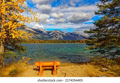 Bench on the shore of a mountain lake. Mountain lake view. Mountain lake shore. Mountain lake landscape