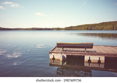 Bench on a wooden floating pier, color toning applied, Lipie Lake in Dlugie Village, Poland. - Shutterstock ID 1987609736