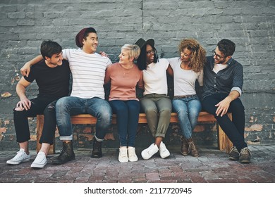 The Bench Of Perpetual Friendship. Shot Of A Diverse Group Of People Chilling Together Outside.