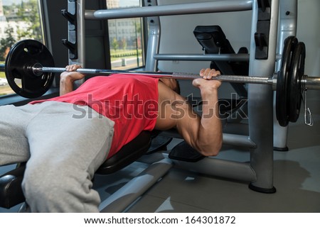 Bench Press At Gym. Young Men In Gym Exercising On The BenchPress