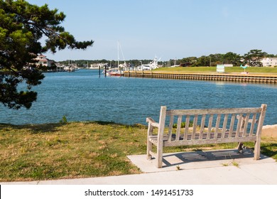 A Bench Sits Facing Lake Wesley At Rudee Inlet In Virginia Beach, Virginia.