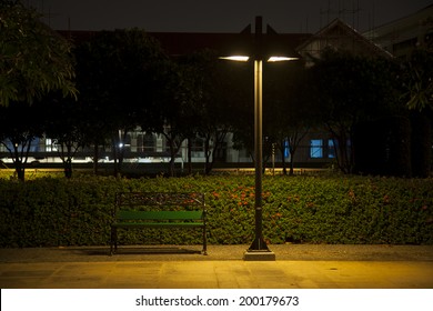 Bench under lamp In a park during the night. - Powered by Shutterstock