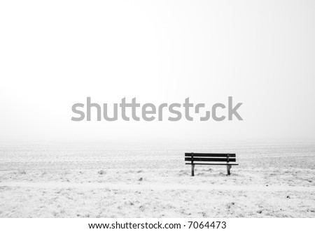 bench in white winter-landscape