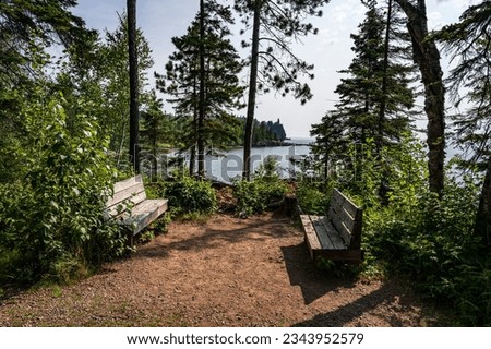 Benches on the Lake Superior Shore with a View of Split Rock Lighthouse in Minnesota Imagine de stoc © 