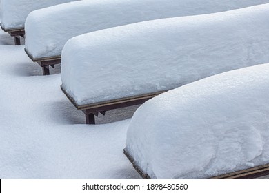 Benches At An Outdoor Concert Venue In A City Park, Covered In Snow, After A Heavy Snowfall