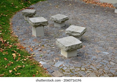 benches in the shape of mushrooms made of solid carved stone. connection of block and stone slabs, for paving near the house. chairs firmly situated in groups of five