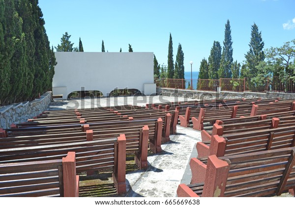 Benches\
for spectators and a movie screen in the open\
air