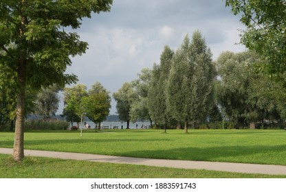 Benches at the water, in a green park landscape at the Chiemsee in Bernau, Germany