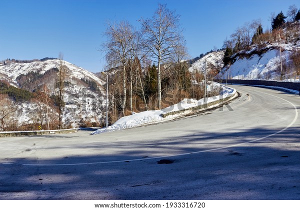 bend in
an asphalt mountain road on a steep descent
