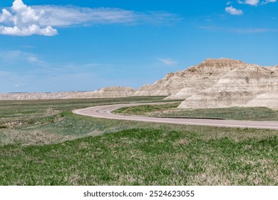 A bend in Highway 240 running along edge of badlands rock formations in Badlands National Park, South Dakota. - Powered by Shutterstock