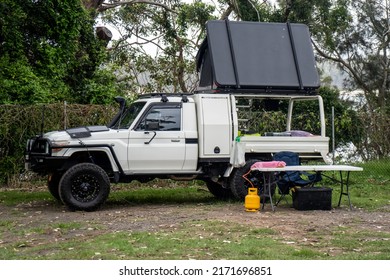 Bendalong, Australia 2021-12-22 Ute pick up vehicle with rooftop tent camping on a campsite. Minimalistic camp setup. Road trip vacation