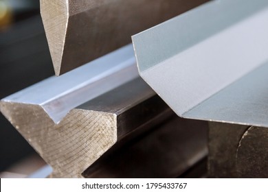 Bending sheet metal with a hydraulic machine at the factory - Shutterstock ID 1795433767
