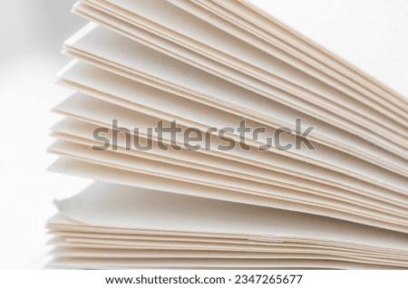 Bending stack of paper sheets, open magazine with copy space