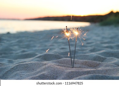 Bengal lights on the sand near the sea on a sunset background
 - Powered by Shutterstock