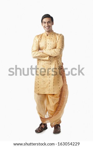 Bengali man standing with his arms crossed and smiling