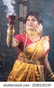 Bengali Married Women Performing Dhunuchi Dance On The Occasion Of Durga Puja With Sari And Gold Jewelry