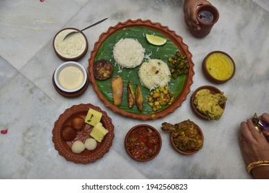 Bengali Meal Served In Earthen Plates ( Paes, Rice, Fish, Chicken, Meat, Chutney, Misti, Chutney )