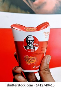 Bengaluru, India - 30th May 2019 : A Man Holding KFC Chicken Popcorn Bucket At Local KFC Store. KFC Is A Popular American Fast Food Chain Known For It's Friend Chicken