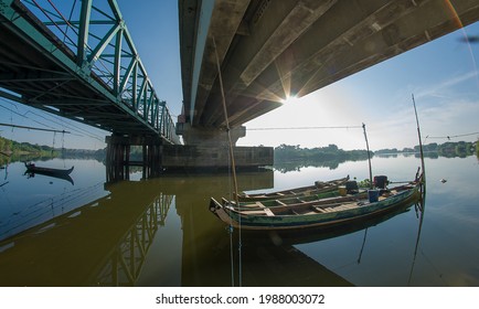 Bengawan Solo River View With 2 Small Boats Parked Under The Bridge