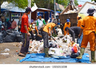 Bengkulu, Indonesia - September 11, 2019: Garbage Man On The Street Collecting Plastic Waste In The Truck.