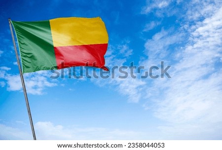 Benin Flag - The colorful flag of Benin fluttering gracefully. This flag features vertical bands of green, yellow, and red, representing the country's lush natural beauty, its history, and its bravery