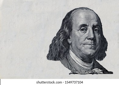 Benjamin Franklin cut on old 100 dollars banknote isolated on white background