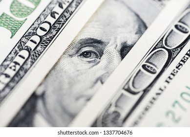 Benjamin Franklin's eyes from a hundred-dollar bill. The face of Benjamin Franklin on the hundred dollar banknote, backgrounds, close-up. 100 dollar bill with only eyes of Benjamin Franklin