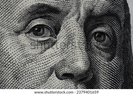 Benjamin Franklin's eyes from a hundred-dollar bill. The eyes of Benjamin Franklin on the hundred dollar banknote, backgrounds, close-up. 100 dollar bill with only eyes of Benjamin Franklin