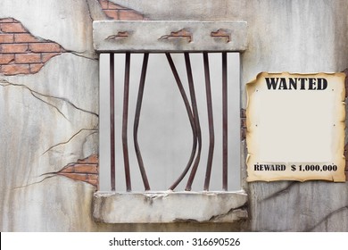 Bent jail bars after a prison break with wanted reward billboard