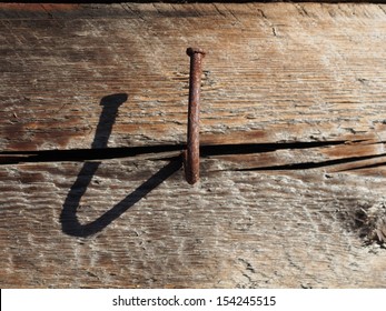 bent nail into a wooden wall
