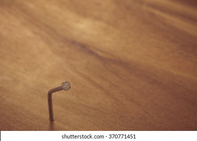 Bent nail on the wood.