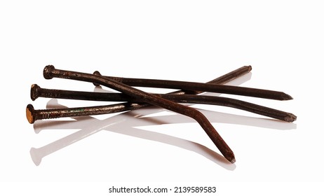 Bent old, rusty nails on a white background