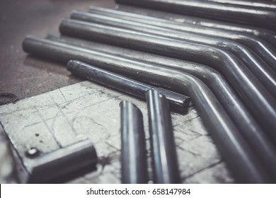 Bent Steel Pipe On A Work Bench.