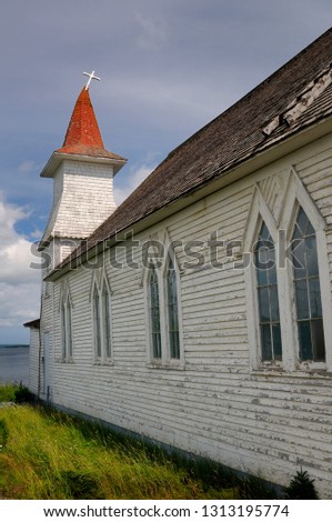Bent steeple with cross of Anglican Christ Church at Clarke's Head Gander Bay Newfoundland