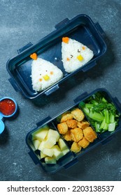 Bento Box With Chicken's Character With Nuggets, Vegetables, Slice Of Apples And Tomato Sauce.  