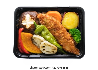 Bento box with vegetables and fried fish, isolated on white background