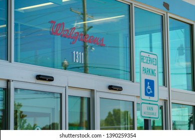 Bentonville, Arkansas / USA - May 05 2019: Walgreens sign on glass front store, Disabled Parking Handicap Parking Sign